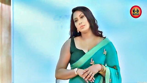Seductive Indian woman in teal saree with deep cleavage