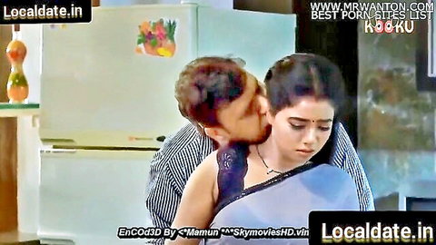 Indian man passionately kisses saree-clad beauty's neck in kitchen embrace