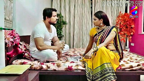 Indian village girl in yellow saree teasing man on bed