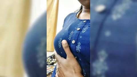 Busty Indian desi woman in blue salwar kameez squeezing breast teasingly