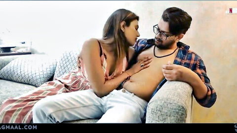 Intimate Indian couple in foreplay, woman in dress touching shirtless man