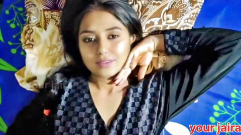 Desi Jaira Ali in seductive pose on bed wearing black checkered top