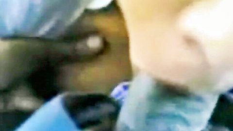 Blurry closeup of young woman's face with blue fabric and shiny eyes in dim light
