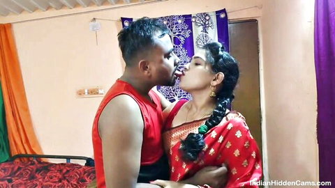 Indian couple passionately kissing in bedroom with wife in red saree hidden cam