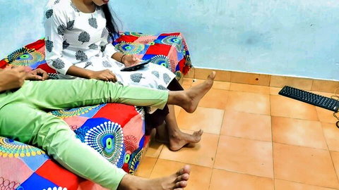 Indian step-sister and bhabhi in kurtas and pants on bed, feet visible