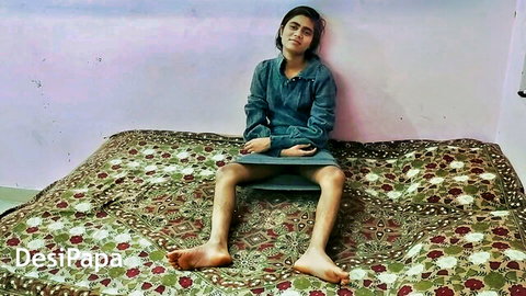Young Desi Indian teen babe sitting legs spread on bed in shorts and hoodie teasing