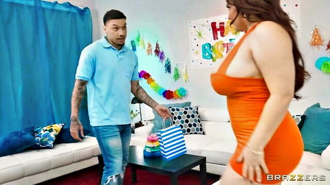 Natasha Nice in low-cut orange dress teases stepson at birthday party
