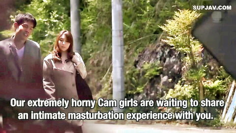 Clothed Japanese man in suit walks with woman in coat outdoors in park before sex