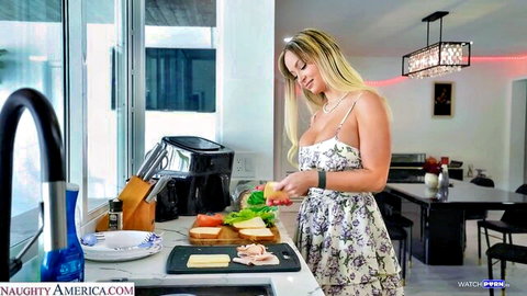 Curvy blonde with huge fake tits in lowcut floral dress chopping veggies on kitchen counter