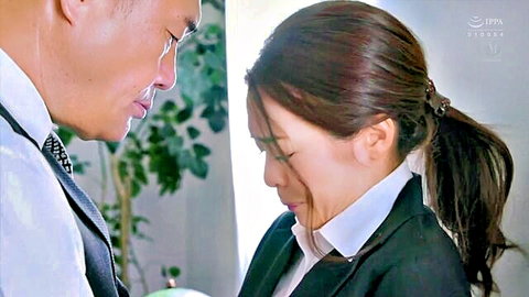 Asian office lady in suit passionately kissing suited man close-up romantic encounter