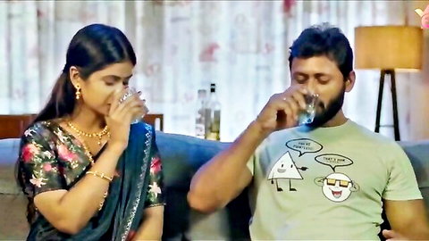 Indian woman in saree drinks water with bearded man in t-shirt