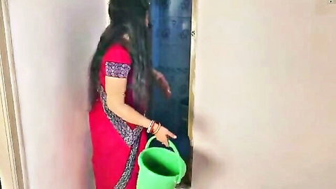 Indian village aunty in red saree holding green bucket, mature curves