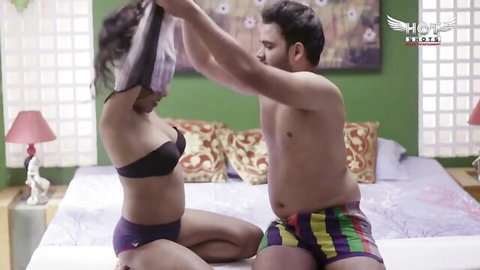 Indian couple in erotic bedroom intimacy with lingerie and embrace