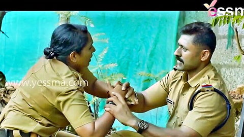 Indian couple in police uniforms holding hands intimately