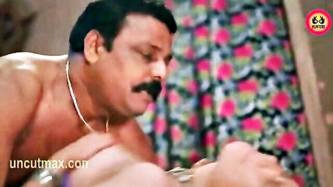 Shirtless mature Indian man fondling woman's breasts in passionate Hindi hot scene