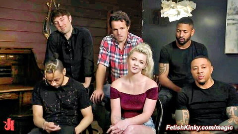 Blonde babe smiling with five diverse studs in FetishKinky gangbang promo