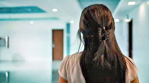 Asian woman with long dark hair in light top, walking away in teasing scene